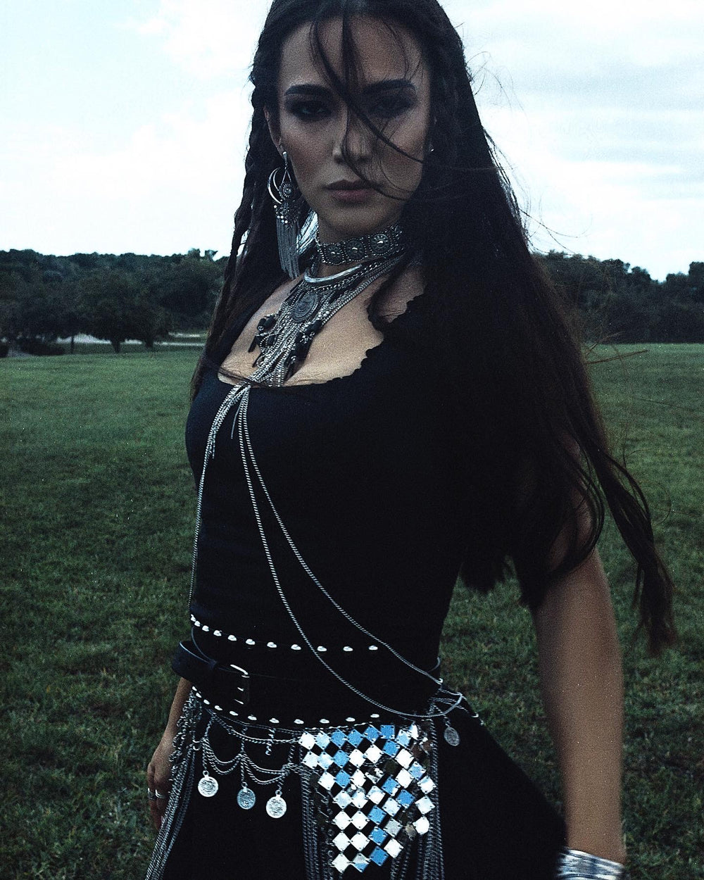 Creative outdoor portrait of Siranush Ambartsumian in a black fashion look with silver accessories.